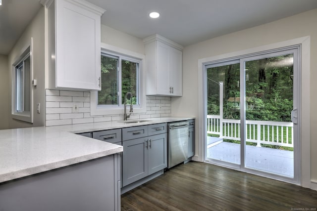 13 School St, Monroe, CT 06468 - kitchen featuring stainless steel dishwasher, tasteful backsplash, dark wood-style floors, light stone countertops, and gray cabinetry