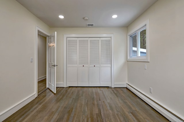 13 School St, Monroe, CT 06468 - unfurnished bedroom with baseboard heating, wood finished floors, a closet, and recessed lighting