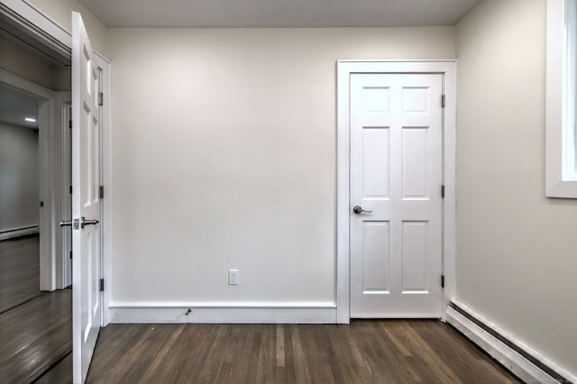 13 School St, Monroe, CT 06468 - unfurnished room with baseboard heating, dark wood finished floors, and a baseboard heating unit