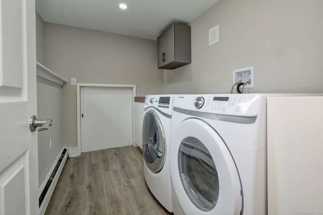 13 School St, Monroe, CT 06468 - washroom featuring a baseboard radiator, separate washer and dryer, light wood-style flooring, and cabinet space