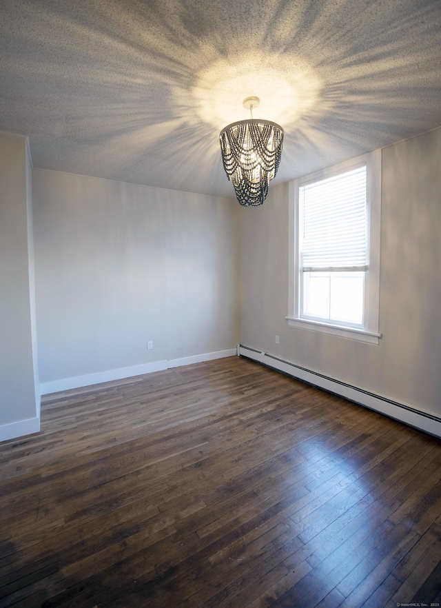 214 Broadway, Norwich, CT 06360 - unfurnished room with a chandelier, baseboard heating, and dark wood-style flooring