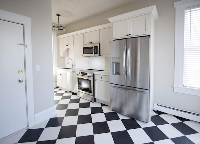 214 Broadway, Norwich, CT 06360 - kitchen with stainless steel appliances, tile patterned floors, a chandelier, light countertops, and white cabinetry