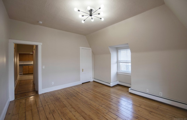214 Broadway, Norwich, CT 06360 - additional living space with a chandelier, a baseboard heating unit, vaulted ceiling, and hardwood / wood-style floors