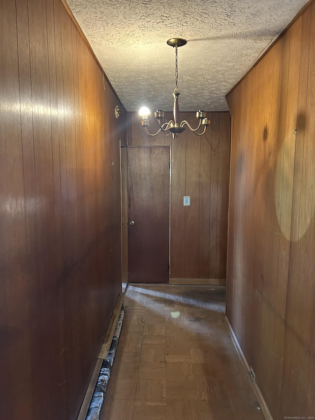 36 Boswell Ave, Norwich, CT 06360 - corridor featuring wood walls, a chandelier, and a textured ceiling