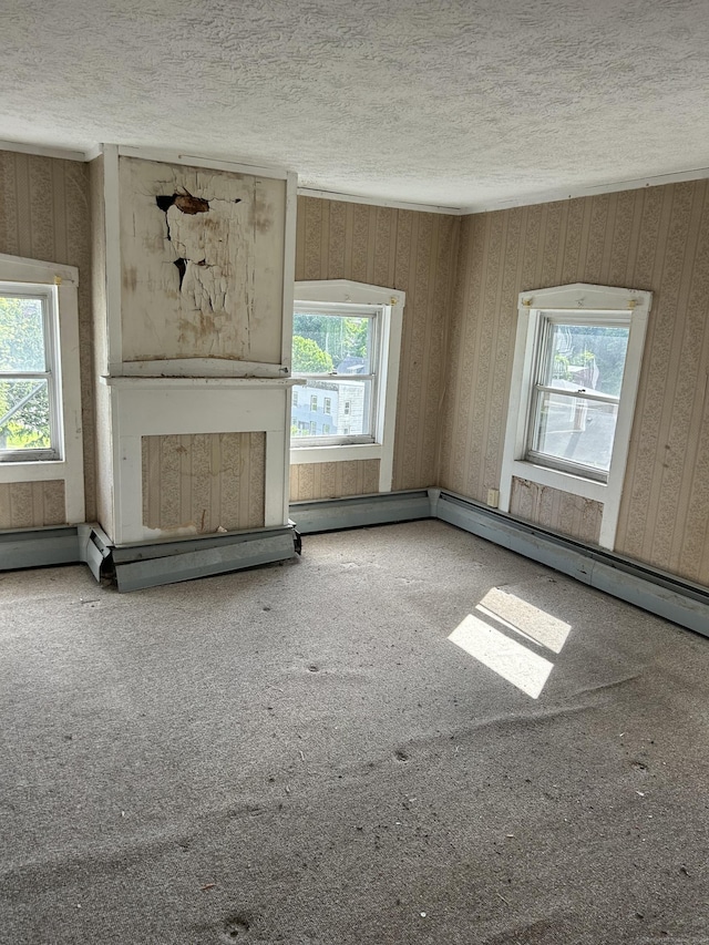 36 Boswell Ave, Norwich, CT 06360 - unfurnished living room with a textured ceiling, healthy amount of natural light, wallpapered walls, and carpet flooring