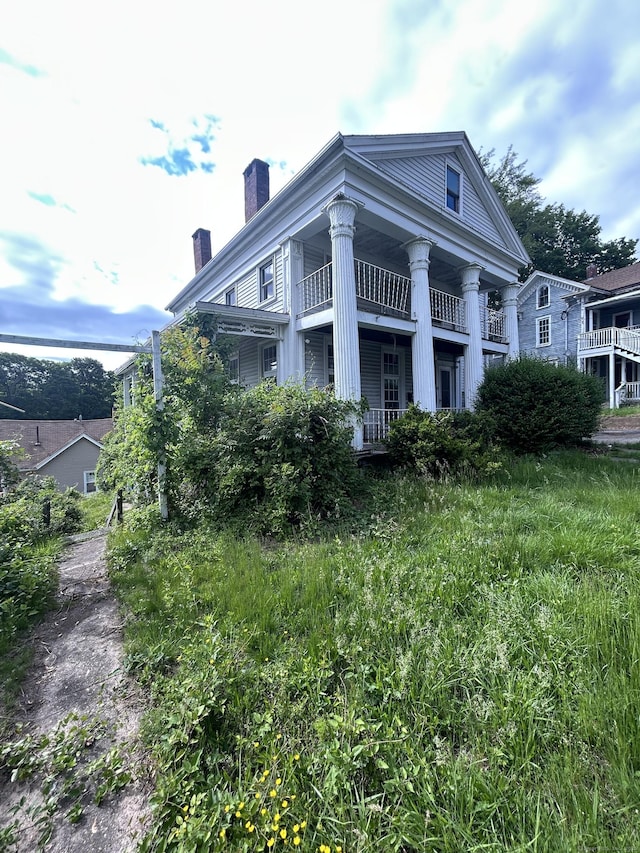 36 Boswell Ave, Norwich, CT 06360 - view of side of property featuring a chimney and a balcony