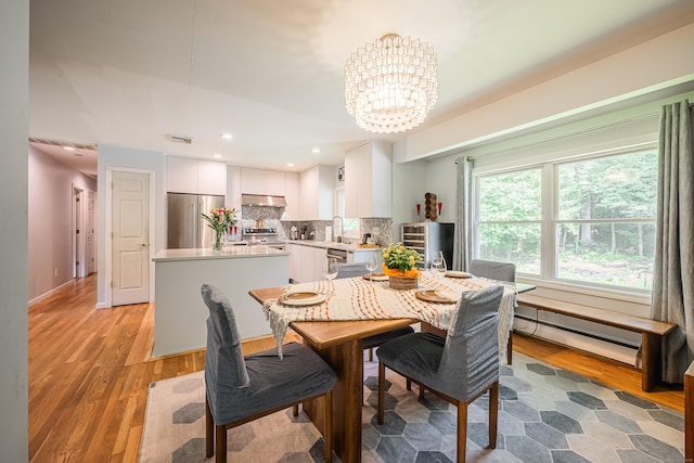 4 Northrop Rd, Woodbridge, CT 06525 - dining space with a baseboard heating unit, a chandelier, light wood-style floors, and recessed lighting