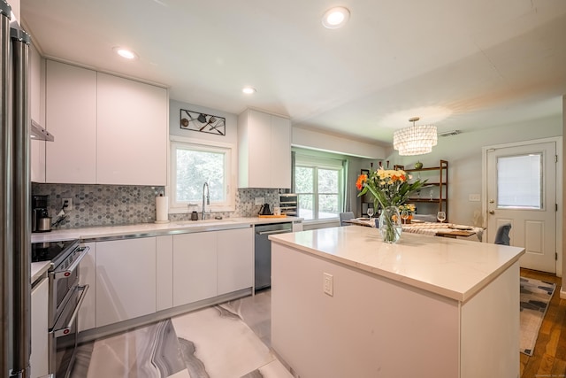 4 Northrop Rd, Woodbridge, CT 06525 - kitchen featuring appliances with stainless steel finishes, backsplash, a kitchen island, white cabinets, and recessed lighting