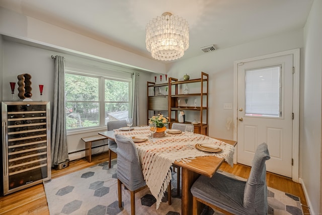 4 Northrop Rd, Woodbridge, CT 06525 - dining space with wine cooler, a chandelier, light wood-style flooring, and baseboard heating