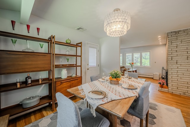4 Northrop Rd, Woodbridge, CT 06525 - dining space with wood finished floors, a baseboard radiator, a chandelier, and a fireplace