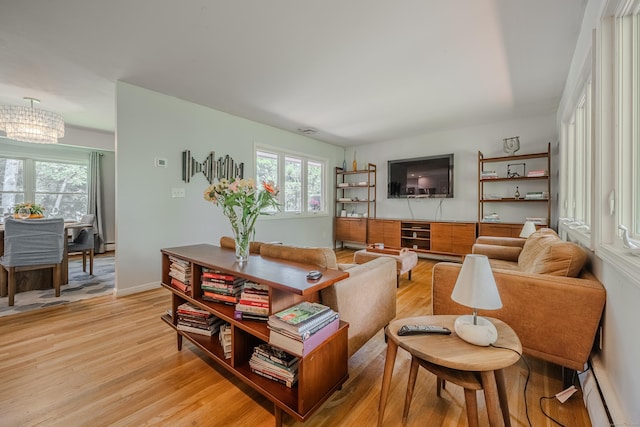 4 Northrop Rd, Woodbridge, CT 06525 - living room with light wood-style flooring, a chandelier, and plenty of natural light