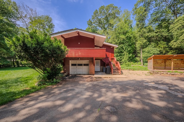 4 Northrop Rd, Woodbridge, CT 06525 - view of property exterior with stairway, asphalt driveway, an attached garage, and brick siding