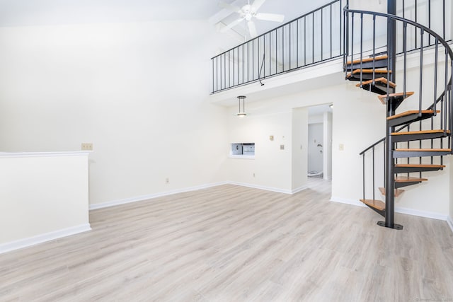 430 Emmett St Apt L, Bristol, CT 06010 - unfurnished living room with stairway, a ceiling fan, wood finished floors, and high vaulted ceiling