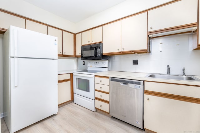 430 Emmett St Apt L, Bristol, CT 06010 - kitchen featuring white appliances, light wood finished floors, and light countertops