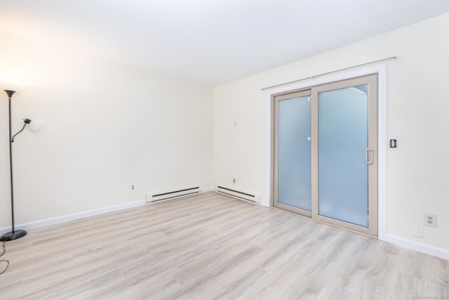 430 Emmett St Apt L, Bristol, CT 06010 - unfurnished room featuring baseboard heating and light wood-style flooring