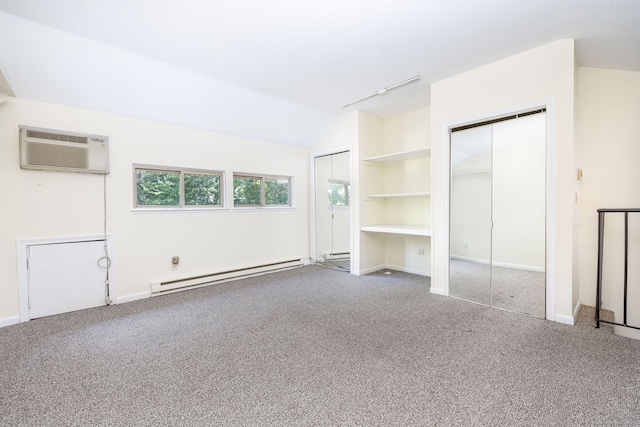 430 Emmett St Apt L, Bristol, CT 06010 - unfurnished bedroom featuring a baseboard heating unit, multiple closets, carpet floors, lofted ceiling, and an AC wall unit