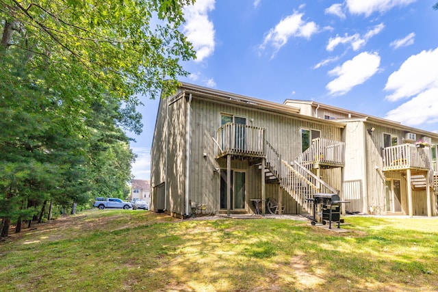 430 Emmett St Apt L, Bristol, CT 06010 - rear view of property featuring stairs, a wooden deck, and a yard