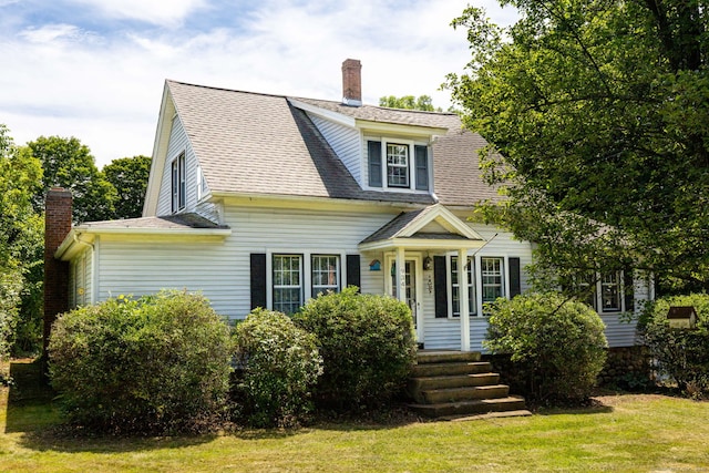 934 Jerome Ave, Bristol, CT 06010 - view of front of house with a chimney, a front lawn, and a shingled roof