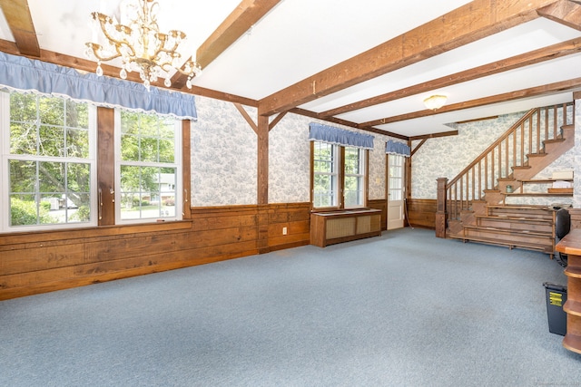934 Jerome Ave, Bristol, CT 06010 - unfurnished living room with a chandelier, wainscoting, plenty of natural light, carpet floors, and beam ceiling