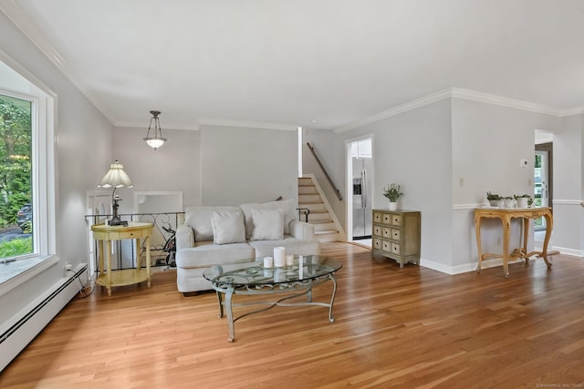 70 Bayne St, Norwalk, CT 06851 - living room featuring a baseboard heating unit, plenty of natural light, light wood-style flooring, ornamental molding, and stairs