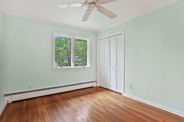 70 Bayne St, Norwalk, CT 06851 - unfurnished bedroom featuring a baseboard radiator, crown molding, hardwood / wood-style flooring, a closet, and ceiling fan