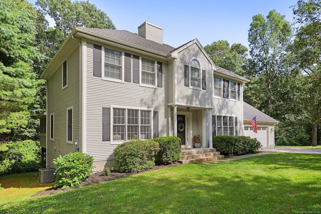 30 Poppy Ln, East Lyme, CT 06333 - colonial home with a front yard, a chimney, a garage, and driveway