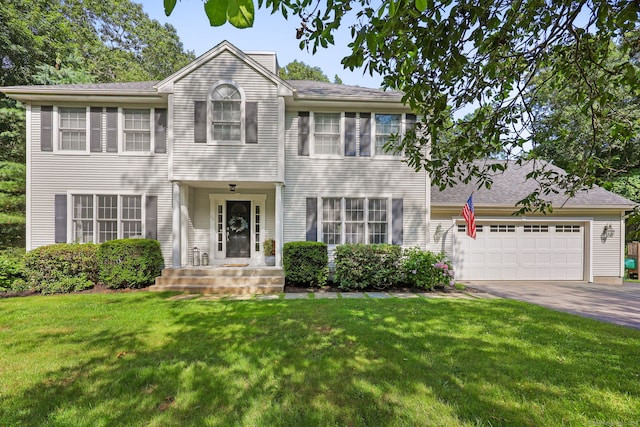 30 Poppy Ln, East Lyme, CT 06333 - colonial home featuring asphalt driveway, an attached garage, and a front yard