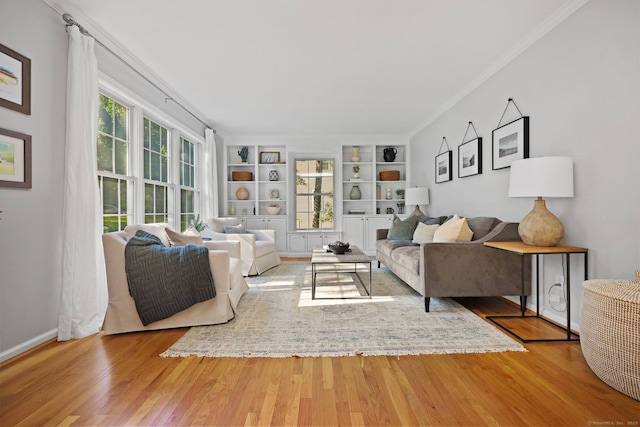 30 Poppy Ln, East Lyme, CT 06333 - living area with wood finished floors, built in shelves, and crown molding