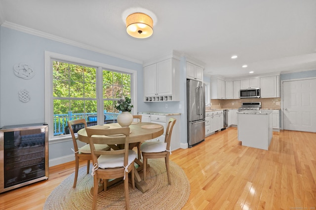 30 Poppy Ln, East Lyme, CT 06333 - dining room with wine cooler, ornamental molding, light wood-style floors, and recessed lighting