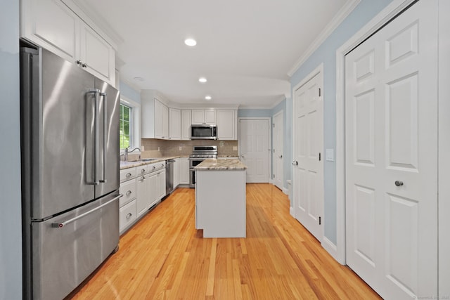 30 Poppy Ln, East Lyme, CT 06333 - kitchen featuring stainless steel appliances, crown molding, white cabinets, a center island, and recessed lighting