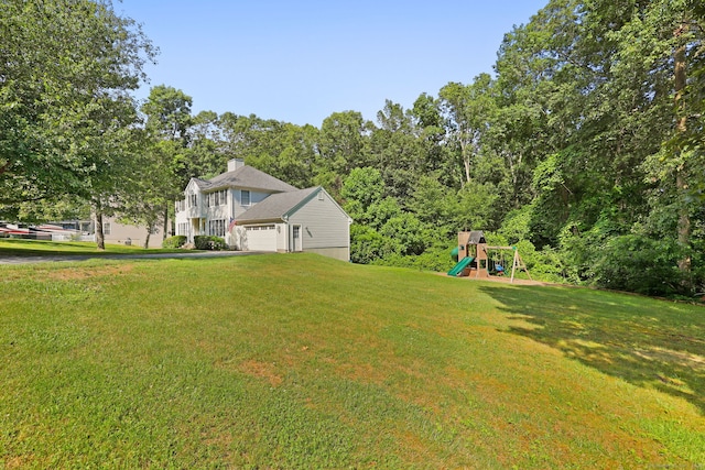 30 Poppy Ln, East Lyme, CT 06333 - view of green lawn featuring a playground and an attached garage