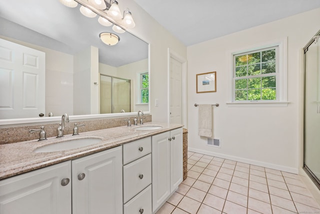 30 Poppy Ln, East Lyme, CT 06333 - full bathroom featuring a shower stall, tile patterned floors, double vanity, and plenty of natural light