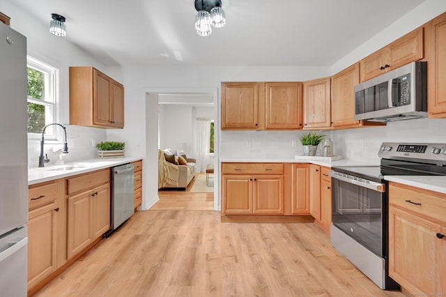 112 Lake Rd, Andover, CT 06232 - kitchen featuring appliances with stainless steel finishes, light brown cabinets, and light wood-type flooring