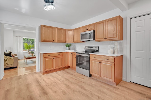 112 Lake Rd, Andover, CT 06232 - kitchen featuring stainless steel appliances, light wood-type flooring, light countertops, and tasteful backsplash