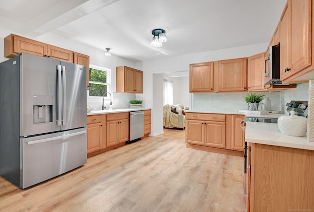 112 Lake Rd, Andover, CT 06232 - kitchen with appliances with stainless steel finishes, tasteful backsplash, light countertops, and light wood finished floors