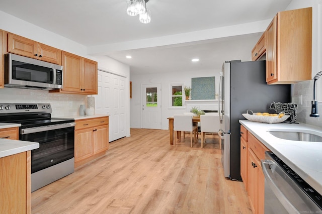 112 Lake Rd, Andover, CT 06232 - kitchen with stainless steel appliances, decorative backsplash, light wood-style floors, and recessed lighting