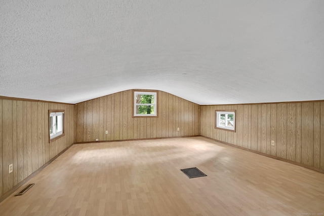 112 Lake Rd, Andover, CT 06232 - bonus room with vaulted ceiling, light wood finished floors, a textured ceiling, and wooden walls