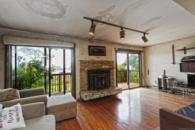 25 Summer Pl, Milford, CT 06460 - living area featuring a fireplace, wood-type flooring, healthy amount of natural light, and baseboard heating