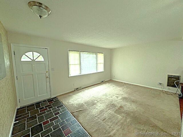21 Eastwood Rd, Bridgeport, CT 06606 - carpeted foyer featuring a textured ceiling and tile patterned flooring