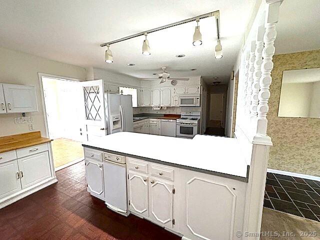21 Eastwood Rd, Bridgeport, CT 06606 - kitchen featuring stainless steel gas range, white microwave, fridge with ice dispenser, a peninsula, and a ceiling fan