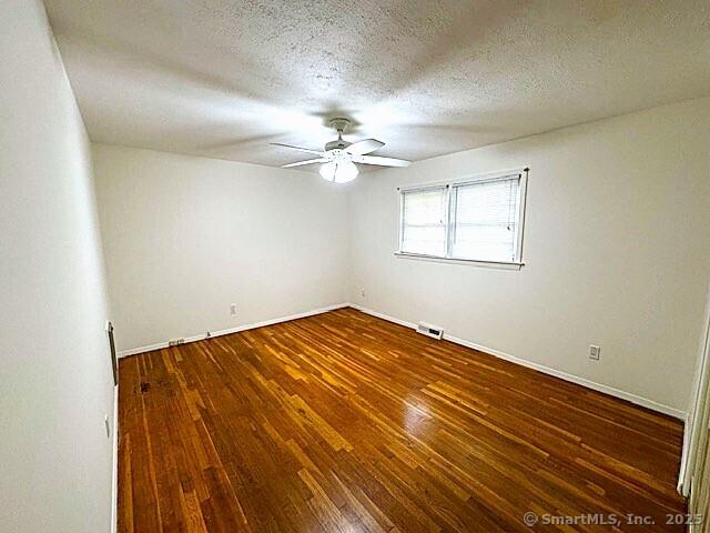 21 Eastwood Rd, Bridgeport, CT 06606 - unfurnished room with ceiling fan, hardwood / wood-style flooring, and a textured ceiling