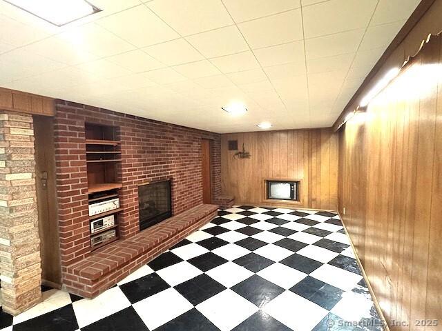 21 Eastwood Rd, Bridgeport, CT 06606 - unfurnished living room with a fireplace, wood walls, and light flooring