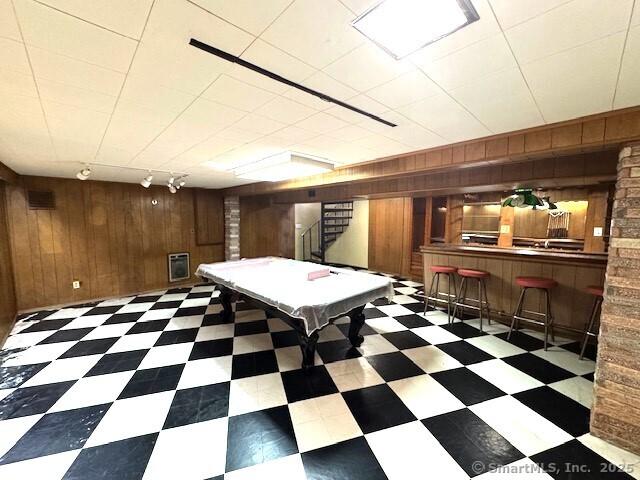 21 Eastwood Rd, Bridgeport, CT 06606 - rec room with wood walls, a dry bar, pool table, track lighting, and tile patterned floors