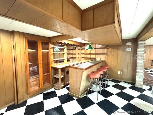 21 Eastwood Rd, Bridgeport, CT 06606 - indoor dry bar featuring tile patterned floors and wood walls