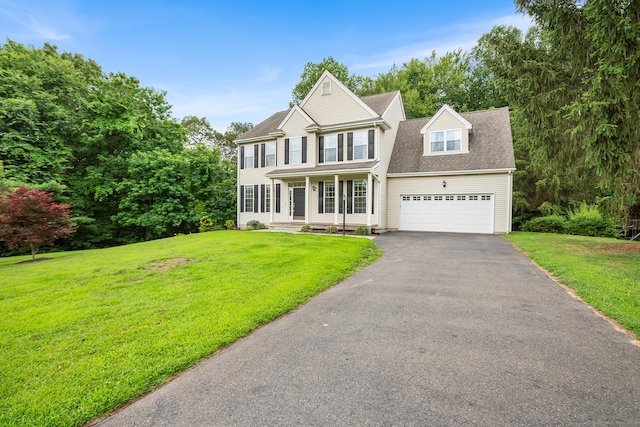 50 Buckingham Rd, Avon, CT 06001 - view of front of property with asphalt driveway, a front yard, covered porch, and an attached garage