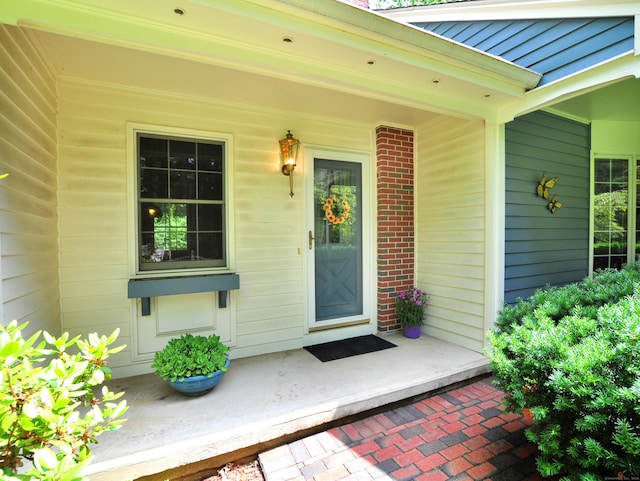 3 Carriage Dr, Canton, CT 06019 - doorway to property featuring covered porch and brick siding