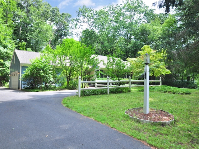3 Carriage Dr, Canton, CT 06019 - view of front facade featuring a front yard, driveway, an attached garage, and view of wooded area