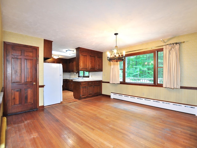 3 Carriage Dr, Canton, CT 06019 - kitchen featuring freestanding refrigerator, baseboard heating, wallpapered walls, a chandelier, and light wood-style floors
