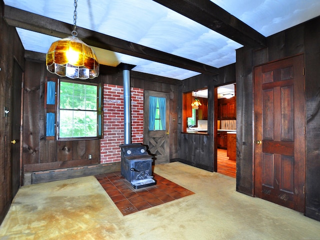 3 Carriage Dr, Canton, CT 06019 - carpeted living room with a wood stove, wood walls, and beam ceiling