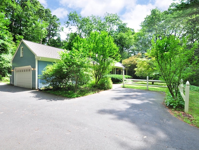 3 Carriage Dr, Canton, CT 06019 - view of front of house featuring a garage, driveway, an outdoor structure, view of scattered trees, and roof with shingles